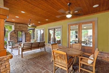 Outdoor patios with tables, chairs and fireplace